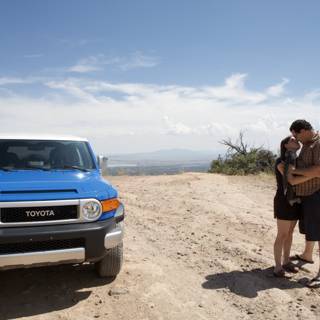 An Adventurous Couple and Their Blue SUV