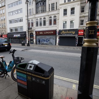 Urban Street Scene with Bike Share and Recycling Bin