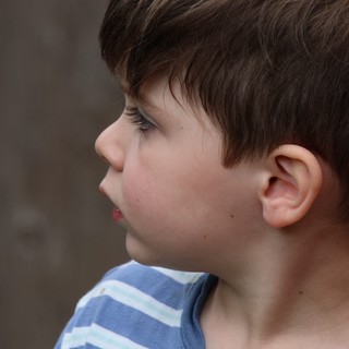 Profile Portrait of Young Boy in Striped Shirt