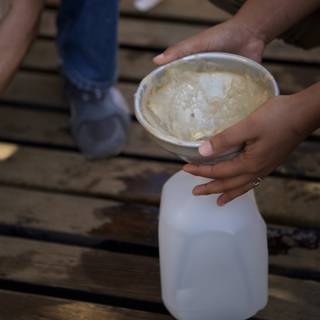 Pouring Milk into Wooden Container