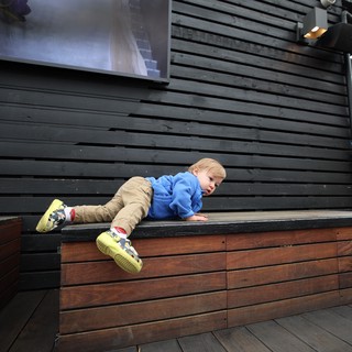 Young Child Climbing Modern Wooden Deck Structure