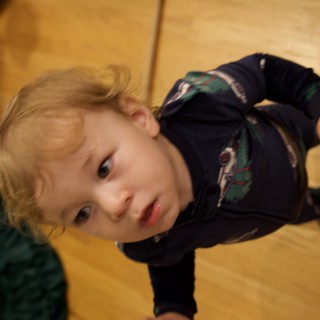 Child Lying on Wooden Floor - Christmas Morning Portrait