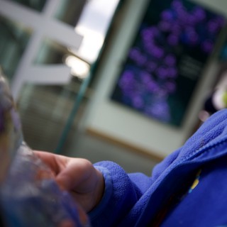 Child in Blue Robe Viewing Purple Science Display