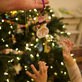 Child Reaching for Handmade Christmas Ornament