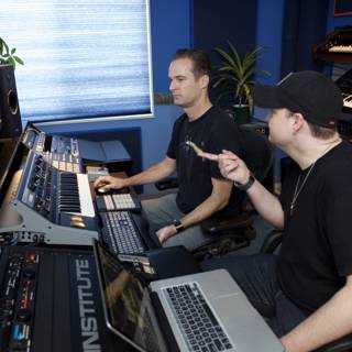 Two Men Creating Electronic Beats in the Recording Studio