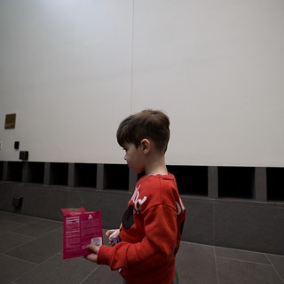 Young Visitor Reading Museum Guide at Asian Art Museum