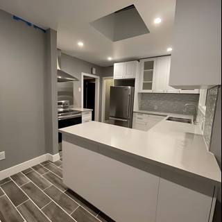 White Kitchen with Modern Appliances and Tile Flooring