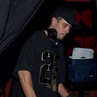 DJ S in Black Shirt and Baseball Cap