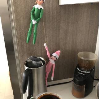 Elf Dolls Perched on a Coffee Maker