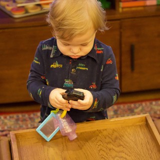 Toddler Playing with Toy Cars at Christmas Time
