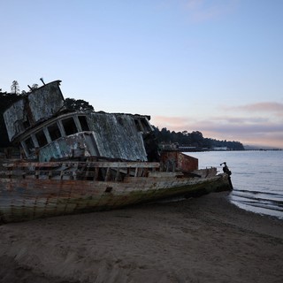 Abandoned Shipwreck on Beach at Twilight