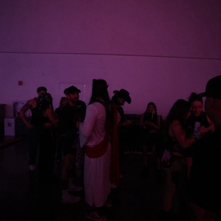 Purple-Lit Crowd Socializing at Wobbleland Festival