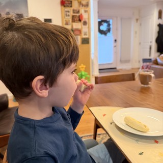 Young Child Enjoying Snack Time at Kitchen Table