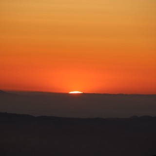 Last Light: Sun Swallowed by Mountain Ridgeline