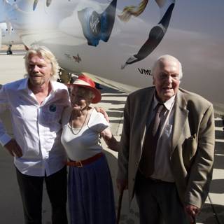 Richard Branson and a Woman Standing Next to an Airplane