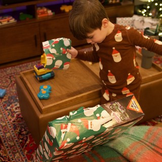 Child Opening Christmas Presents on Holiday Morning