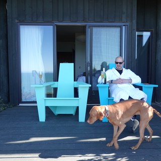 Man Relaxing with Dog on Modern Deck