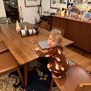 Toddler in Santa Pajamas at Christmas Dining Table