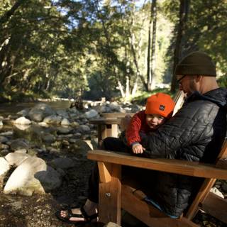 Serenity by the Stream: A Father and Child Moment