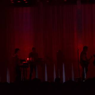 Red Lights on Stage with Performers and Crowd
