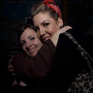 Two Friends Share a Warm Embrace at Night