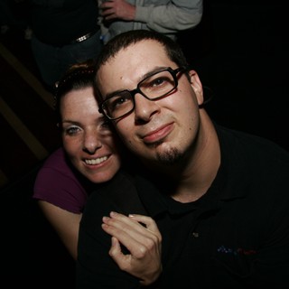 Two Friends Smiling Together at a Nighttime Event