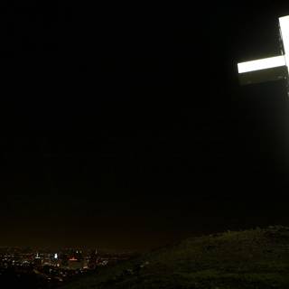 Illuminated Cross Stands Tall Amidst the City