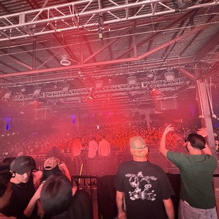 Red-Lit Concert Crowd at Indoor Music Venue