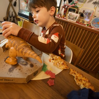 Young Boy Enjoying Pizza on Christmas Day