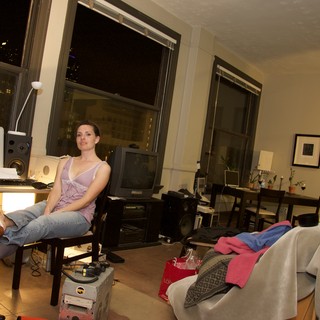 Woman Relaxing in Urban Loft Apartment at Night