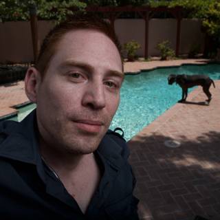 Man and Dog by the Pool
