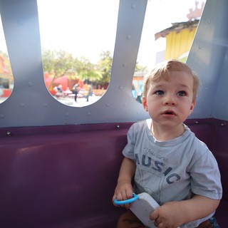 Young Child Enjoying a Theme Park Ride at Disneyland