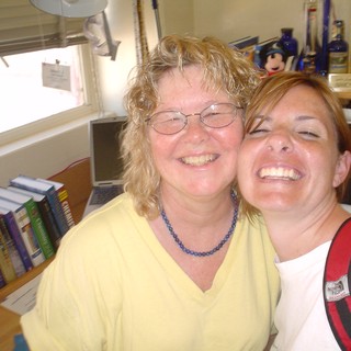 Two Women Laughing Together in Office Setting