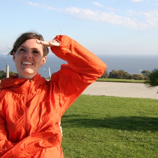Woman in Orange Jacket Gazes at the Pacific Ocean