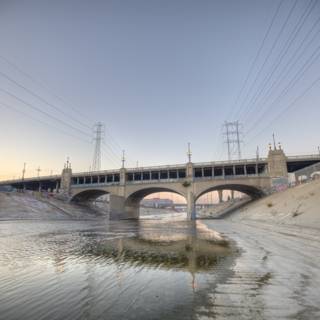 Arch bridge over LA river with power lines