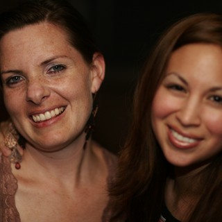 Two Women Smiling at a 2006 Social Gathering