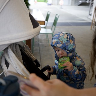 Family Moment at Cafe with Toddler in Blue Snowsuit