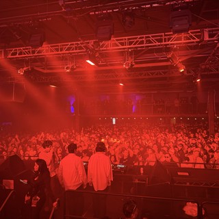 Red-Lit Electronic Music Concert Crowd and Stage