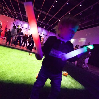 Child with Glowing Lightsaber at Baby Rave Event