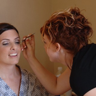 Bridal Makeup Artist Applies Final Touches Before Wedding