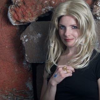 Blonde Halloween Costume Portrait Against Stone Wall