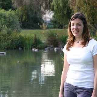 Woman Laughing by a Tranquil Park Pond