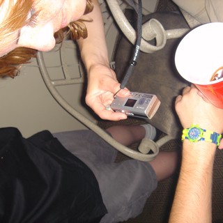 Tech Gadget Inspection at Casual Indoor Gathering