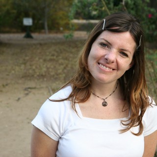 Smiling Woman in White Tee at Outdoor Park