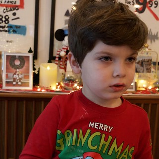 Young Boy in Grinch Christmas Pajamas at Home