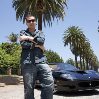Man posing next to a luxurious Ferrari