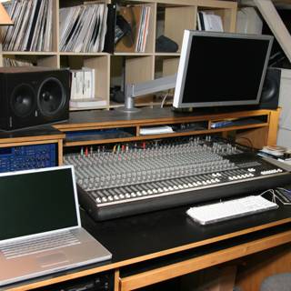 Black Desk with Computer Equipment and Speakers