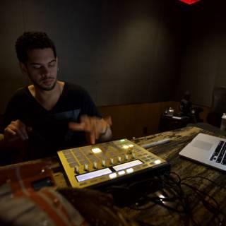 Man Mixing Music on Laptop