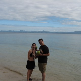 Couple Celebrating Fresh Coconuts on Fijian Beach