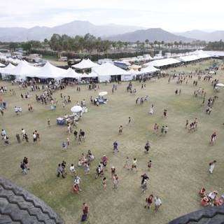 Festival-goers gather for a show on the grassy hill